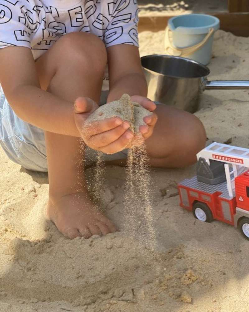 Mura Preschool kid playing sand